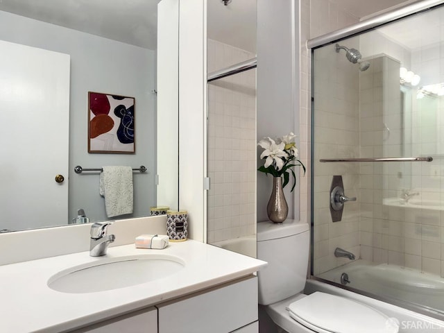 full bathroom with shower / bath combination with glass door, vanity, and toilet