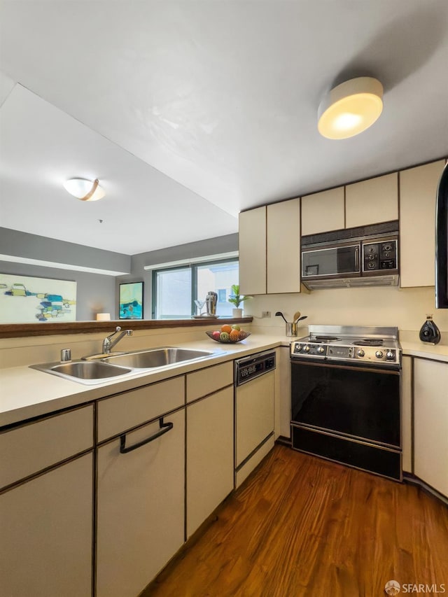 kitchen with range with electric stovetop, light countertops, a sink, black microwave, and dishwasher