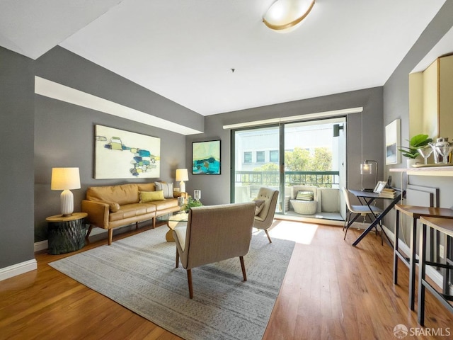 living room featuring baseboards and wood finished floors