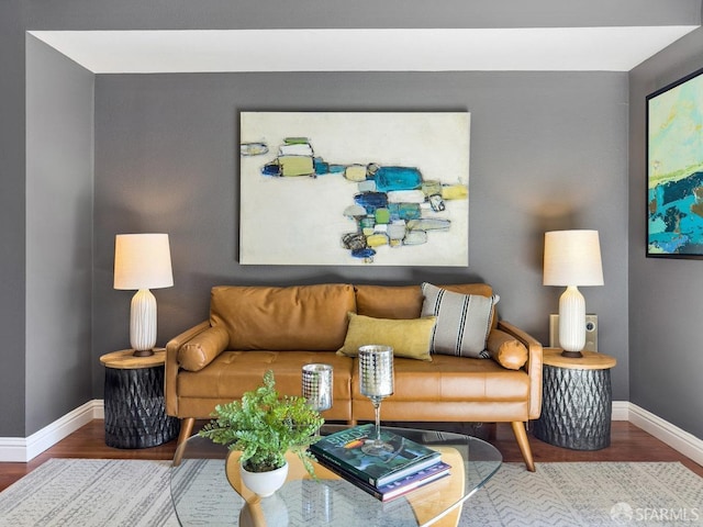 living room with baseboards and wood finished floors