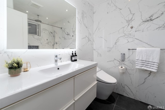 bathroom featuring toilet, vanity, and tile patterned flooring