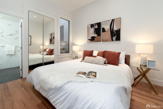 bedroom featuring a closet and hardwood / wood-style flooring