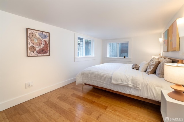 bedroom with hardwood / wood-style floors