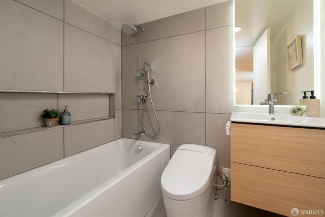 full bathroom featuring tile walls, toilet, vanity, and tiled shower / bath