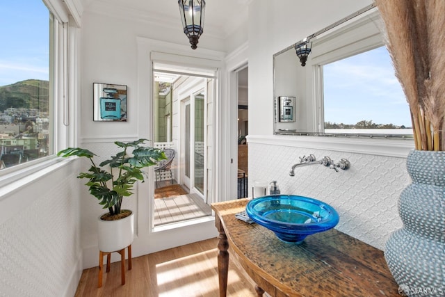 interior space with ornamental molding and wood finished floors