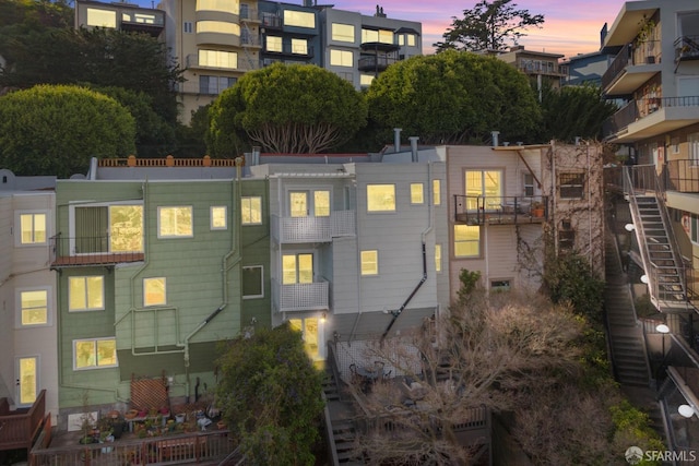 back of property featuring stairway