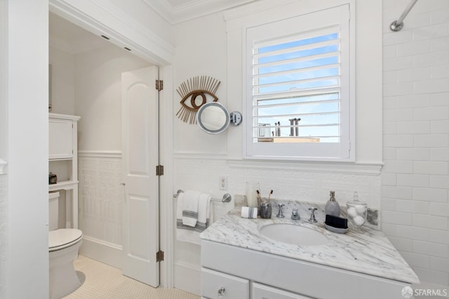 bathroom featuring wainscoting, toilet, ornamental molding, tile patterned floors, and vanity