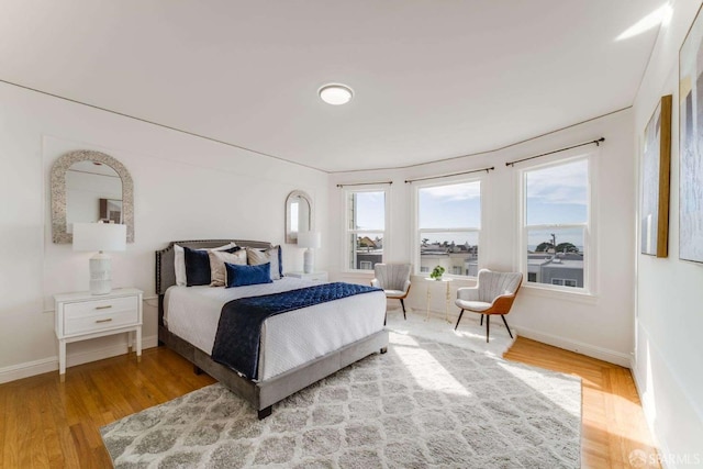 bedroom with wood finished floors and baseboards