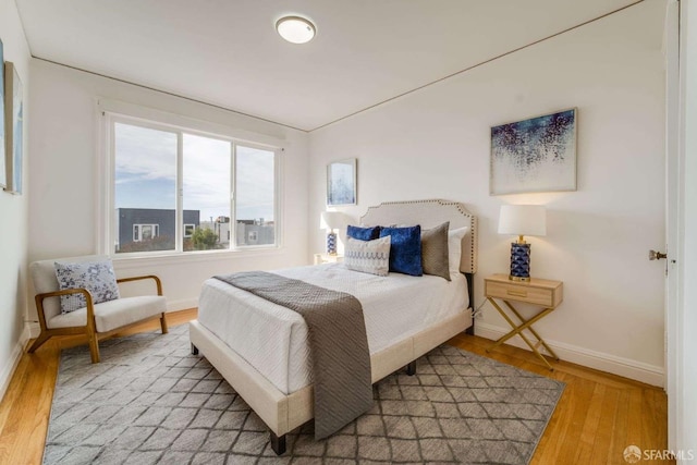 bedroom featuring light wood-style flooring and baseboards