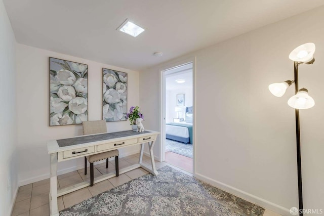 home office featuring light tile patterned floors and baseboards