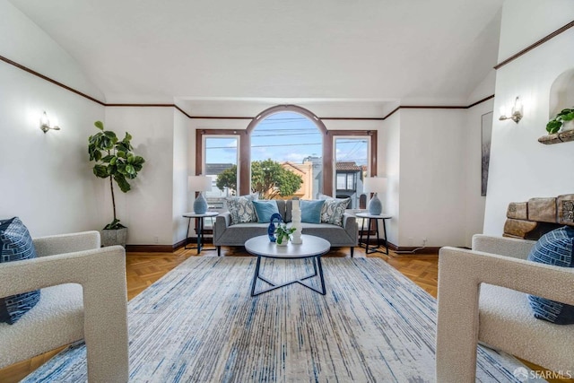 living area with vaulted ceiling, ornamental molding, and baseboards