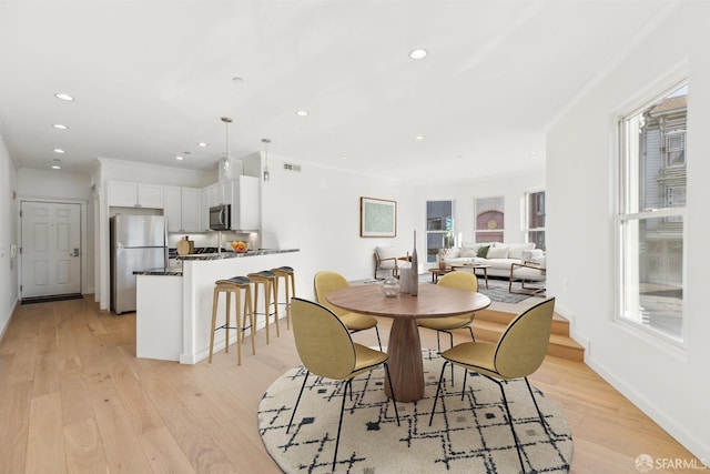 dining area with light hardwood / wood-style floors