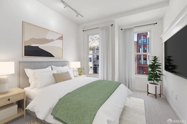 carpeted bedroom with track lighting