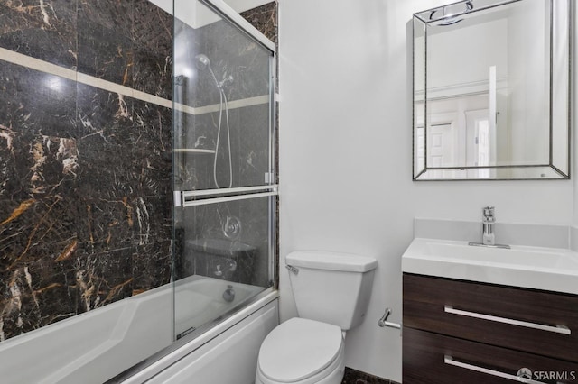 full bathroom with vanity, combined bath / shower with glass door, and toilet