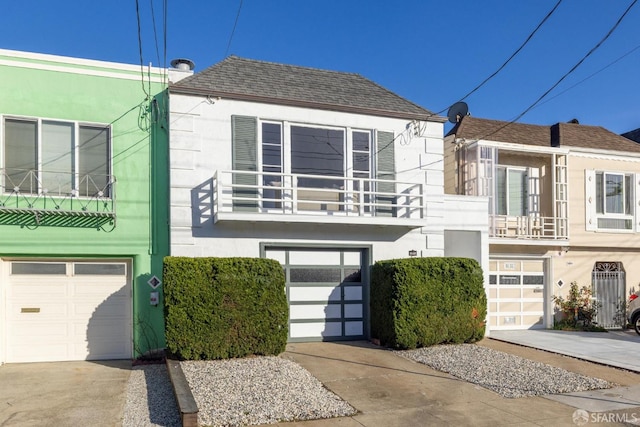 view of front facade featuring a garage and a balcony