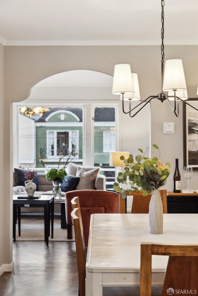 dining area with crown molding, hardwood / wood-style floors, and a wealth of natural light