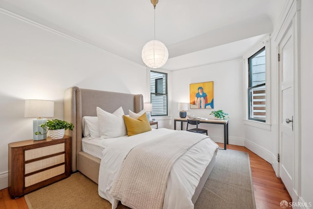 670 Page St, San Francisco, CA 94117 - bedroom featuring wood finished floors, multiple windows, and crown molding