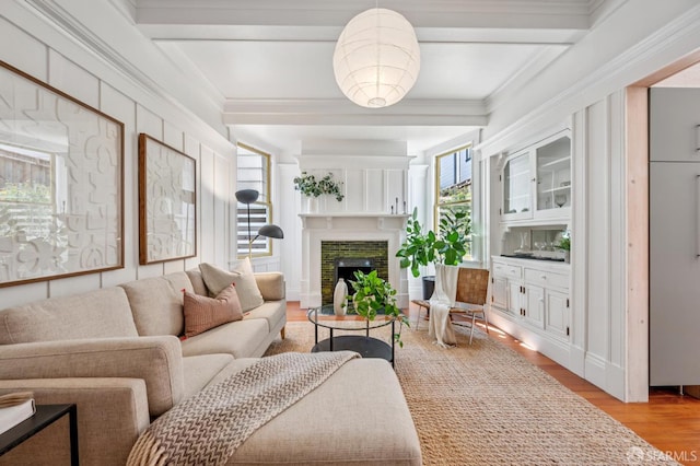 670 Page St, San Francisco, CA 94117 - living room with light wood-type flooring, a fireplace, beamed ceiling, and crown molding