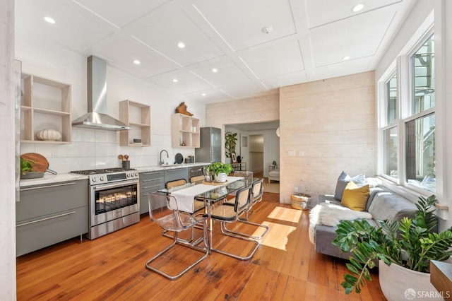 670 Page St, San Francisco, CA 94117 - kitchen with gas range, open shelves, wall chimney range hood, gray cabinetry, and light countertops