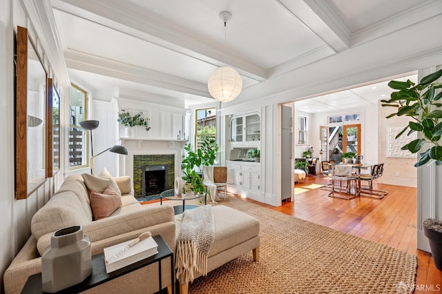 670 Page St, San Francisco, CA 94117 - living area with hardwood / wood-style floors, plenty of natural light, a fireplace, beamed ceiling, and ornamental molding