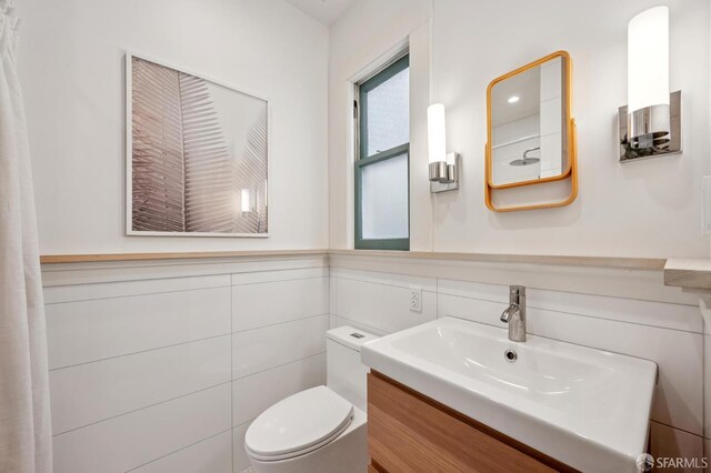 670 Page St, San Francisco, CA 94117 - bathroom with vanity, tile walls, and a wainscoted wall