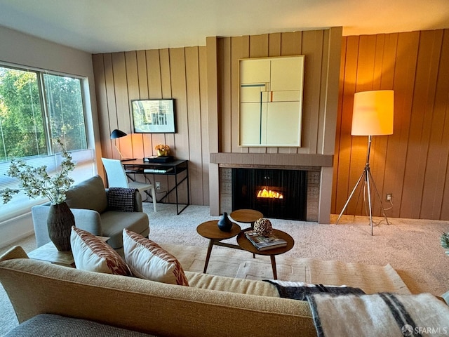 carpeted living room with wood walls