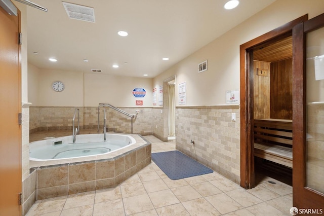 bathroom with a sauna, visible vents, and a garden tub