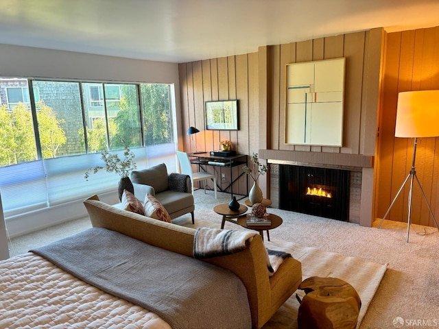 living room featuring wooden walls and carpet