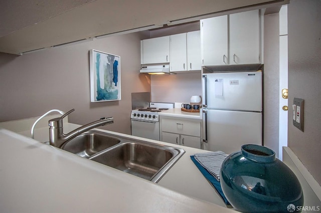 kitchen with under cabinet range hood, a sink, white cabinetry, white appliances, and light countertops