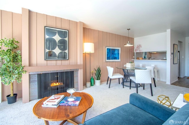 carpeted living room with a fireplace