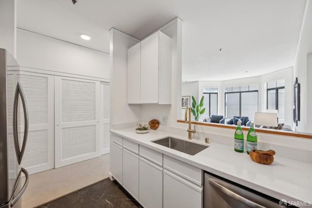 1805 Fillmore St Unit 302, San Francisco, CA 94115 - kitchen featuring stainless steel appliances, a sink, light countertops, white cabinetry, and recessed lighting