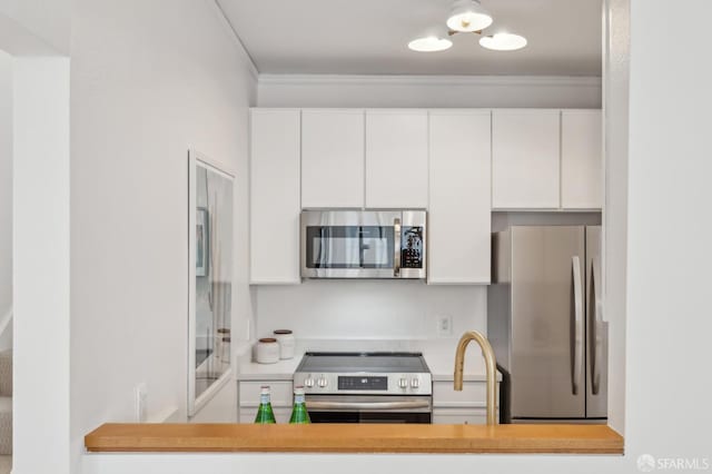 1805 Fillmore St Unit 302, San Francisco, CA 94115 - kitchen with appliances with stainless steel finishes, crown molding, white cabinets, light countertops, and a chandelier