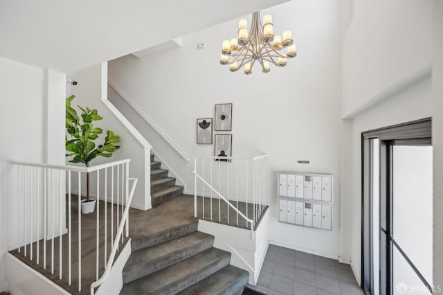 1805 Fillmore St Unit 302, San Francisco, CA 94115 - stairs featuring mail area, a chandelier, a towering ceiling, and baseboards