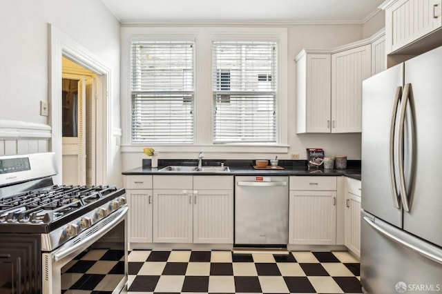 kitchen featuring ornamental molding, appliances with stainless steel finishes, sink, and white cabinets