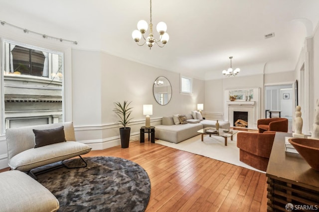 living room featuring hardwood / wood-style flooring and a chandelier