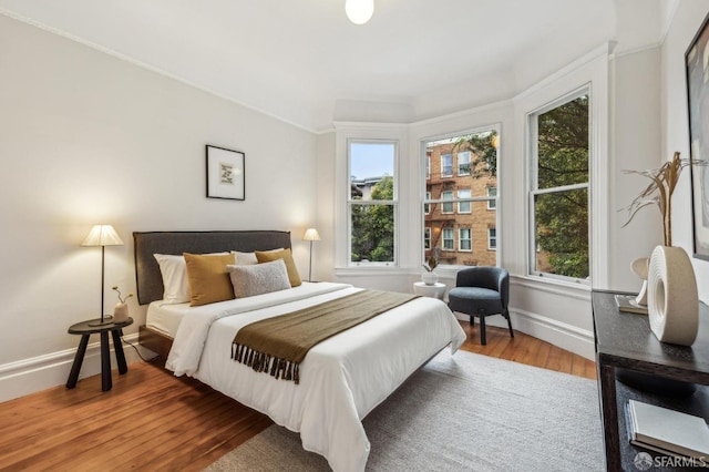 bedroom featuring crown molding and hardwood / wood-style floors