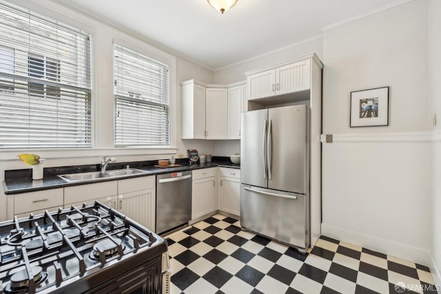 kitchen with crown molding, appliances with stainless steel finishes, sink, and white cabinets