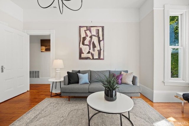 2553 Folsom St Unit A, San Francisco, CA 94110 - living area with a chandelier, wood finished floors, and baseboards