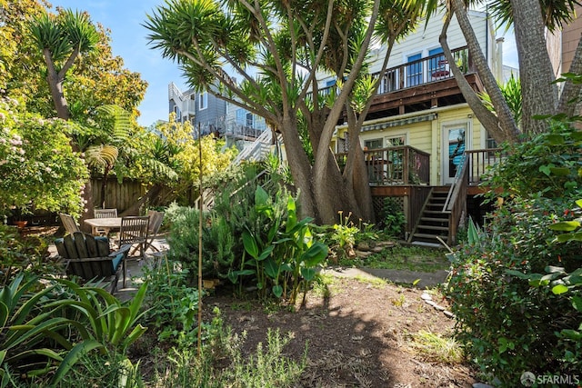 2553 Folsom St Unit A, San Francisco, CA 94110 - view of yard with stairs, a balcony, and a wooden deck