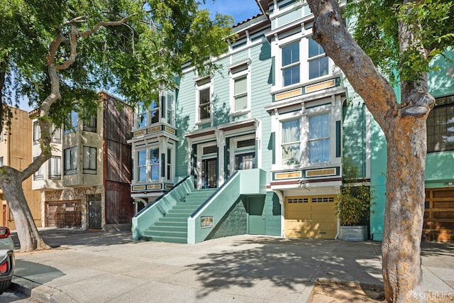2553 Folsom St Unit A, San Francisco, CA 94110 - view of front of house with driveway, stairs, and a garage