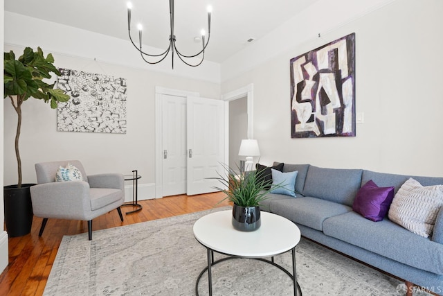 2553 Folsom St Unit A, San Francisco, CA 94110 - living room with wood finished floors, a chandelier, and baseboards