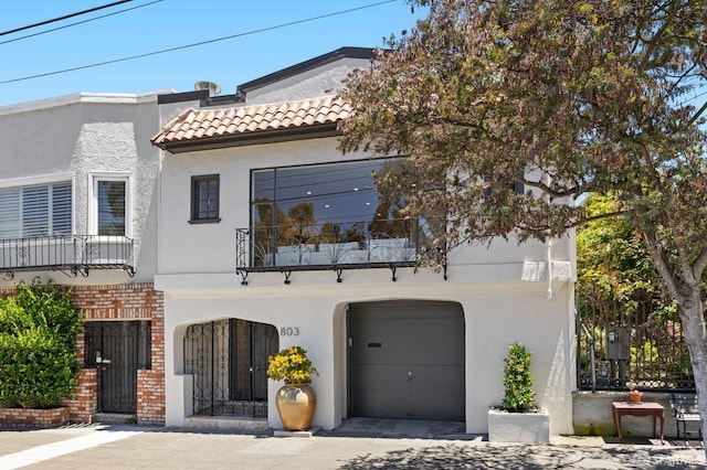 803 Vermont St, San Francisco, CA 94107 - mediterranean / spanish-style home featuring a tile roof, a balcony, stucco siding, and a garage