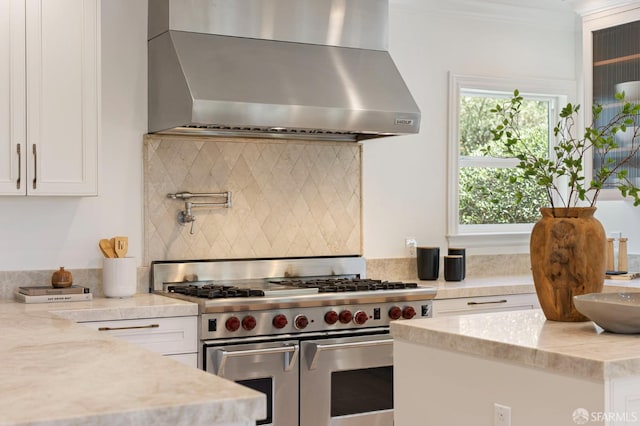 803 Vermont St, San Francisco, CA 94107 - kitchen with wall chimney exhaust hood, double oven range, backsplash, white cabinets, and light stone counters