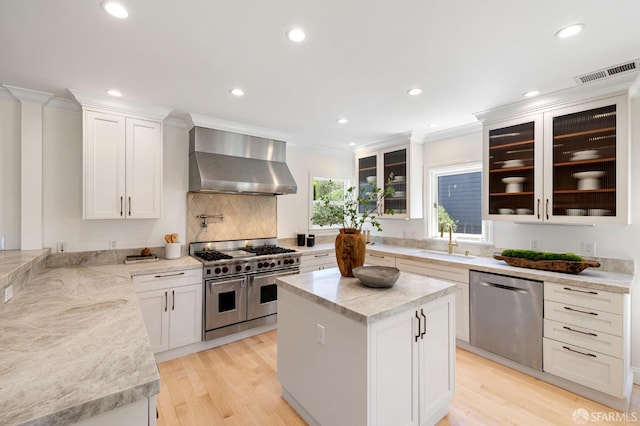 803 Vermont St, San Francisco, CA 94107 - kitchen with wall chimney range hood, stainless steel appliances, crown molding, recessed lighting, and light wood finished floors