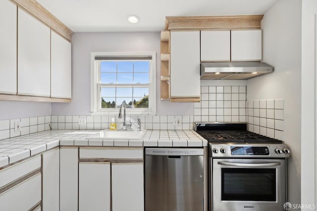 556 Cherry Ave, San Bruno, CA 94066 - kitchen with stainless steel appliances, under cabinet range hood, white cabinets, tasteful backsplash, and recessed lighting