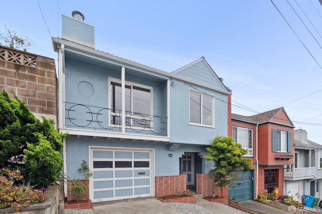 2421 Quintara St, San Francisco, CA 94116 - view of property with an attached garage, stucco siding, a balcony, and a chimney