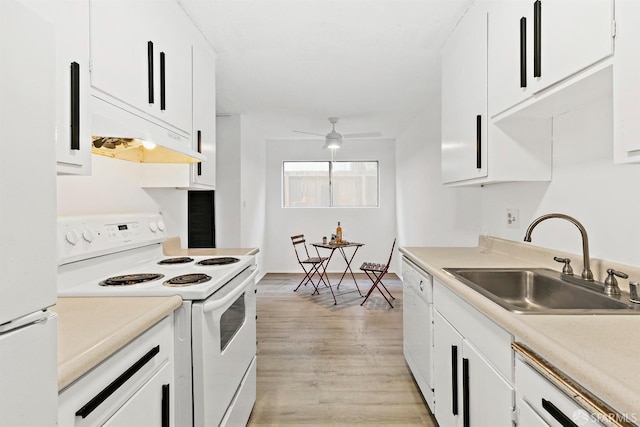 kitchen with light countertops, white cabinets, a sink, white appliances, and under cabinet range hood