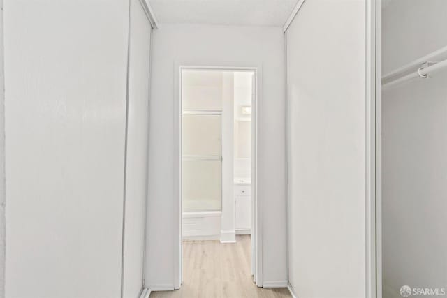 corridor featuring light wood-style flooring