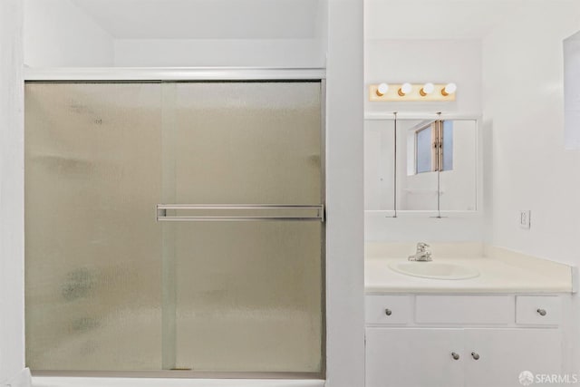 bathroom with a stall shower and vanity