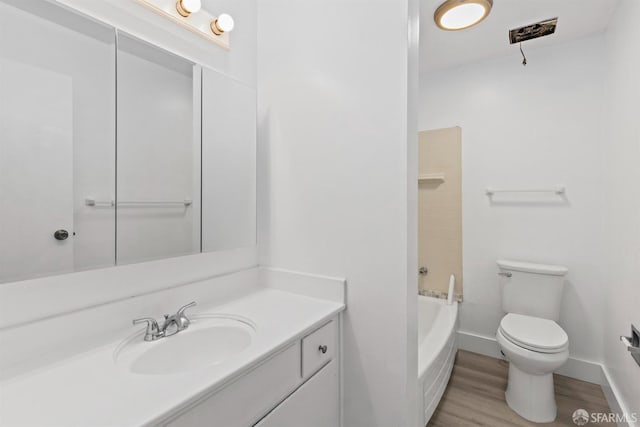 bathroom featuring shower / bath combination, toilet, vanity, wood finished floors, and baseboards